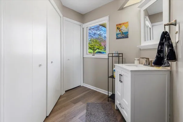 an aerial view of a city with lots of residential buildings ocean and mountain view in back