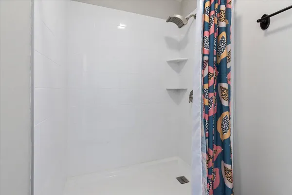 a view of a patio with table and chairs potted plants and large tree