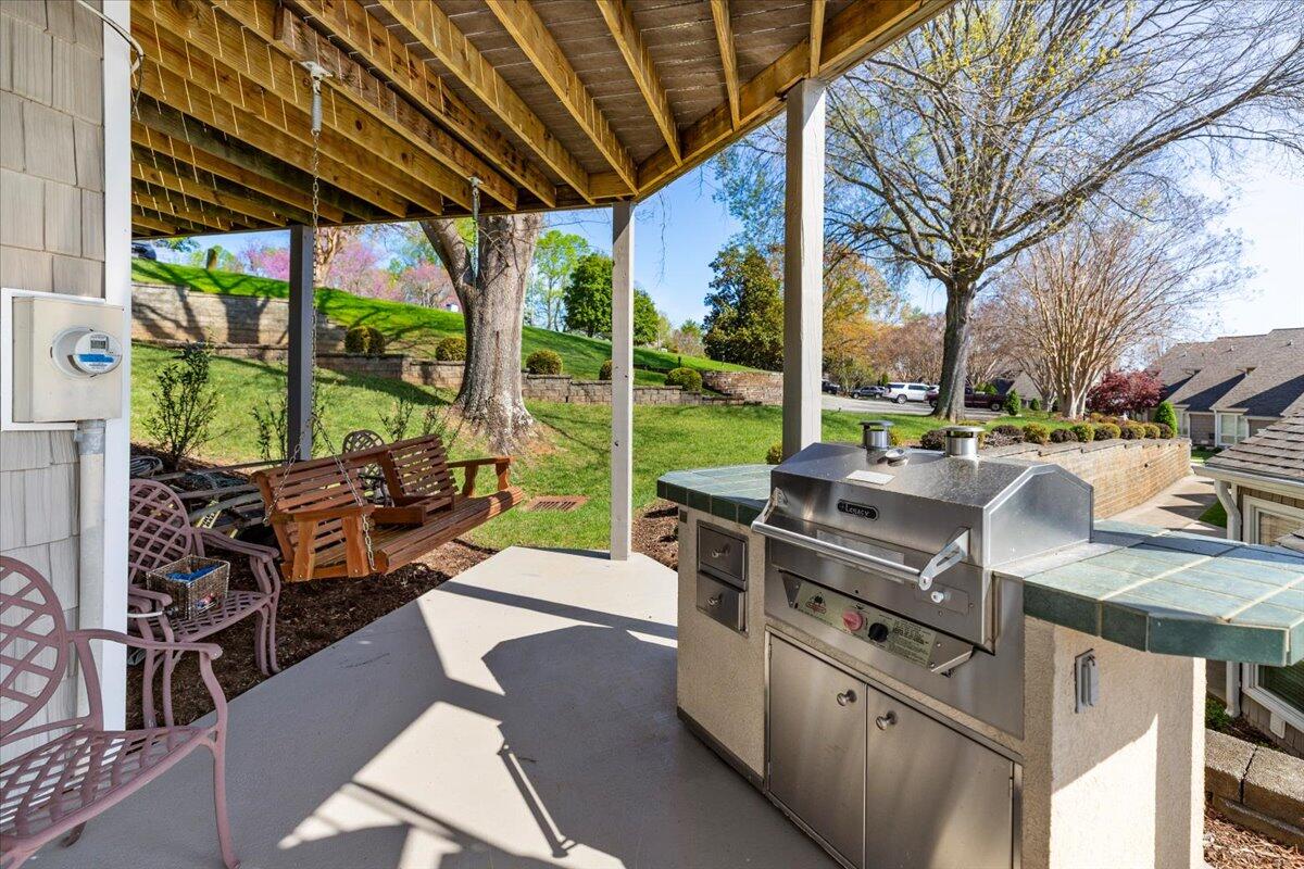 1206 Nature Lane Union Hall, VA 24176 - Photo 52 of 106 a view of a patio with couches chairs dining table and chairs barbeque grill with a small yard and large trees
