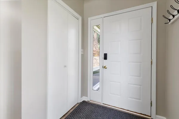 a view of front door and porch with wooden floor