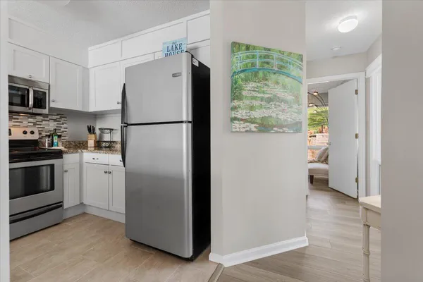a kitchen with granite countertop a sink stove and refrigerator