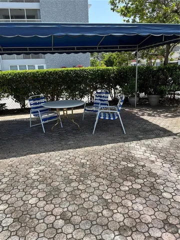 a view of a chairs and table in the patio