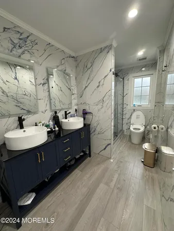 a bathroom with a toilet sink and mirror