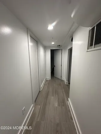 a view of a roof deck with couches and wooden floor