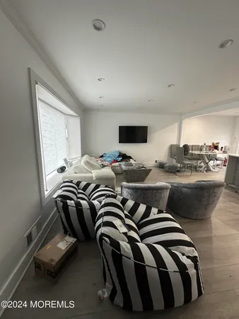 a bedroom with furniture and a wooden floor