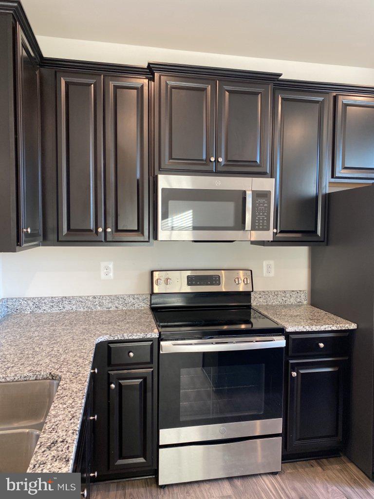 531 View Point Way Fredericksburg, VA 22405 - Photo 22 of 36 Sleek modern kitchen with dark cabinetry.