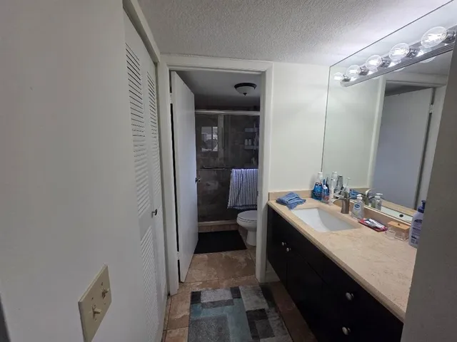 a spacious bathroom with a double vanity sink toilet and shower