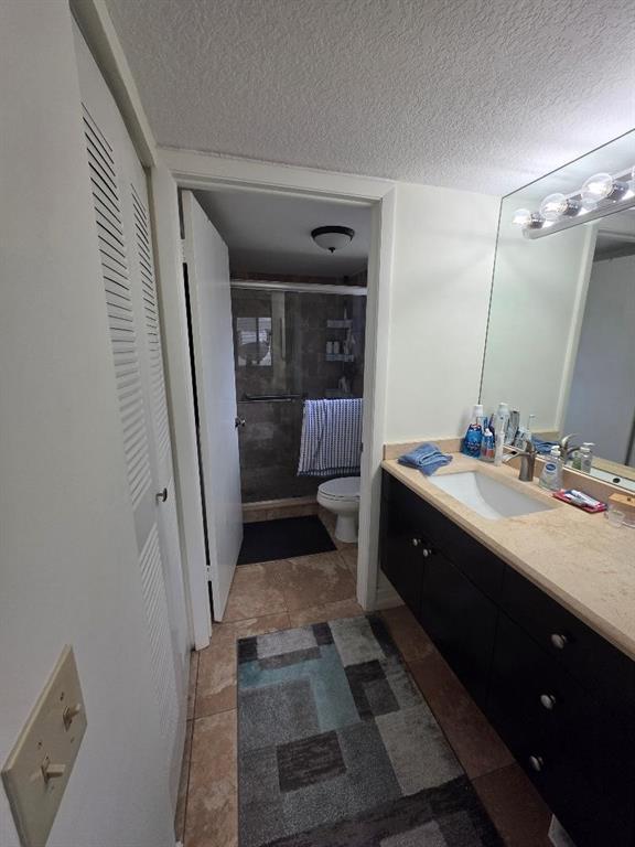5583 Courtyard Drive, Unit 5583 Margate, FL 33063 - Photo 2 of 12 a bathroom with a sink and mirror with toilet