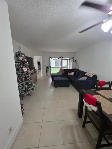 a living room with furniture a couch and a potted plant