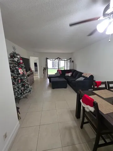 a hallway with a couch and a chandelier