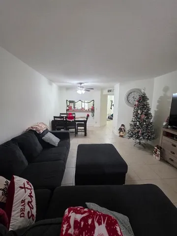 a living room with furniture and a mirror