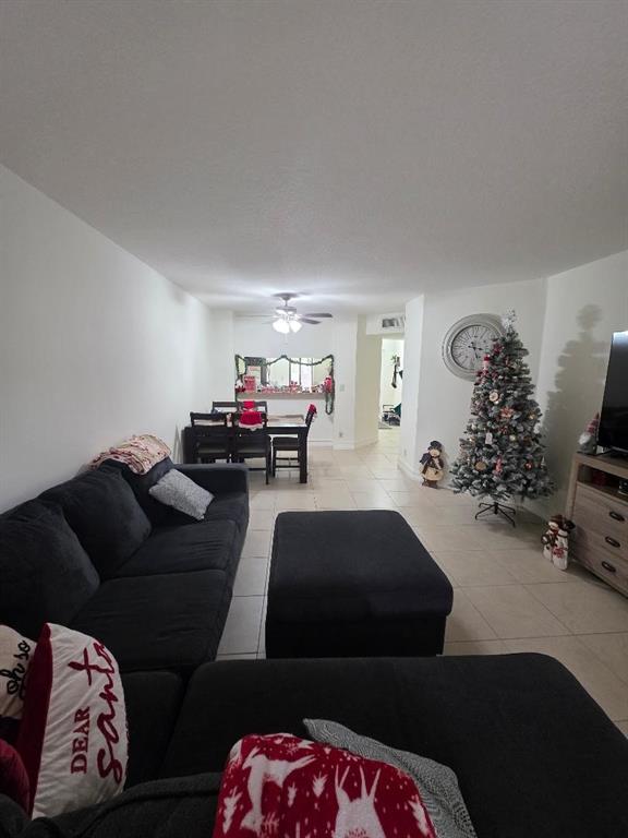 5583 Courtyard Drive, Unit 5583 Margate, FL 33063 - Photo 6 of 12 a living room with furniture and a mirror