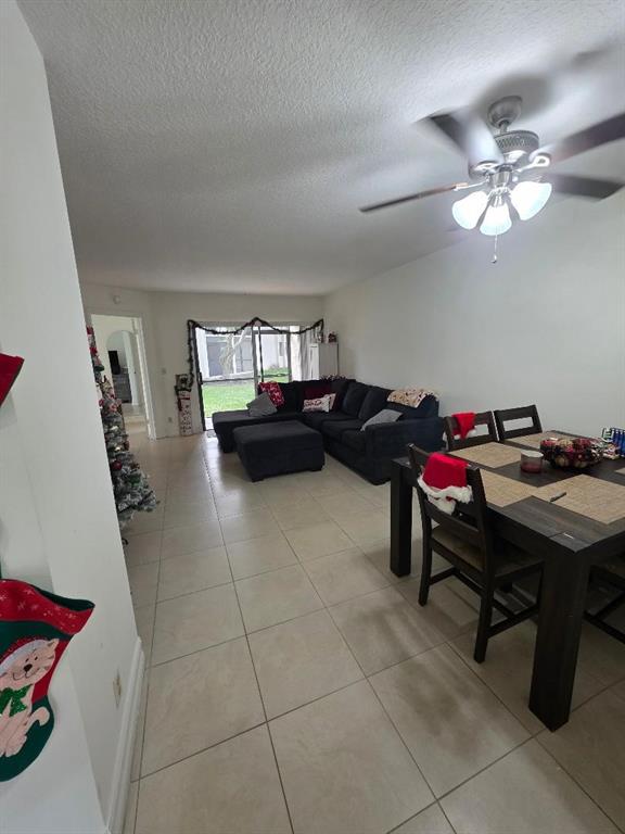 5583 Courtyard Drive, Unit 5583 Margate, FL 33063 - Photo 9 of 12 a living room with furniture and a chandelier