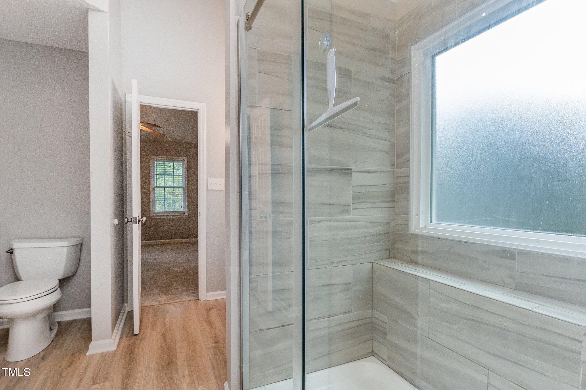 109 Gatepost Lane Cary, NC 27513 - Photo 20 of 37 a bathroom with a toilet and a shower