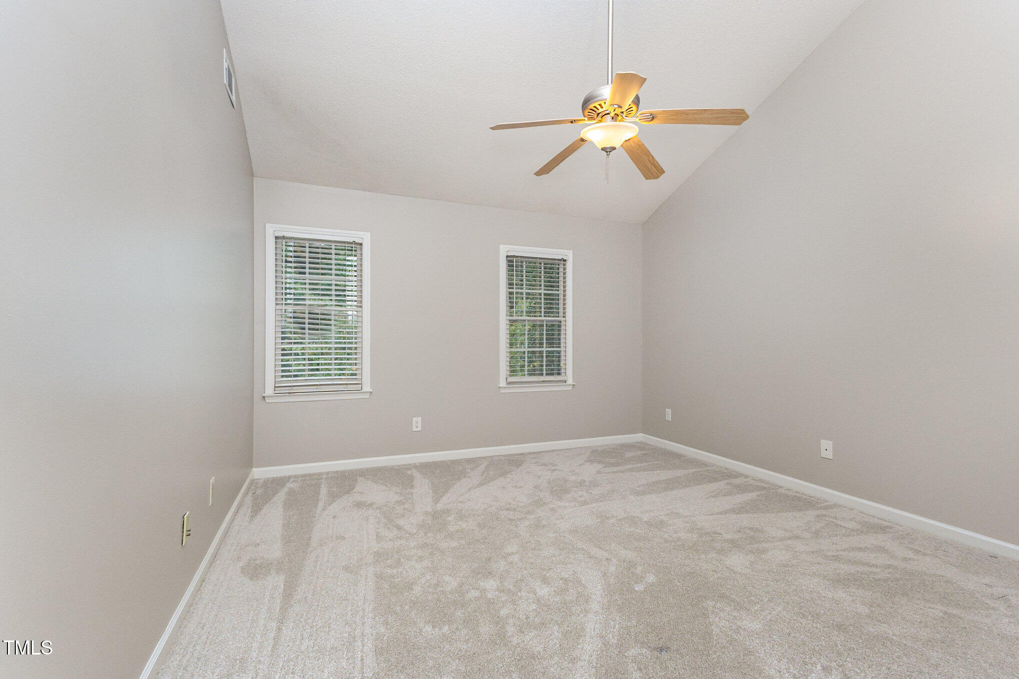 109 Gatepost Lane Cary, NC 27513 - Photo 25 of 37 an empty room with windows and chandelier fan