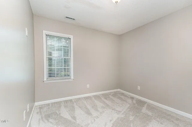 a front view of a house with a garden and yard