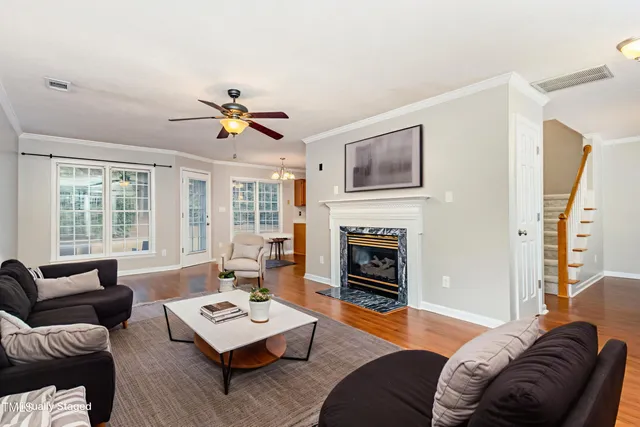 a living room with furniture fireplace and window