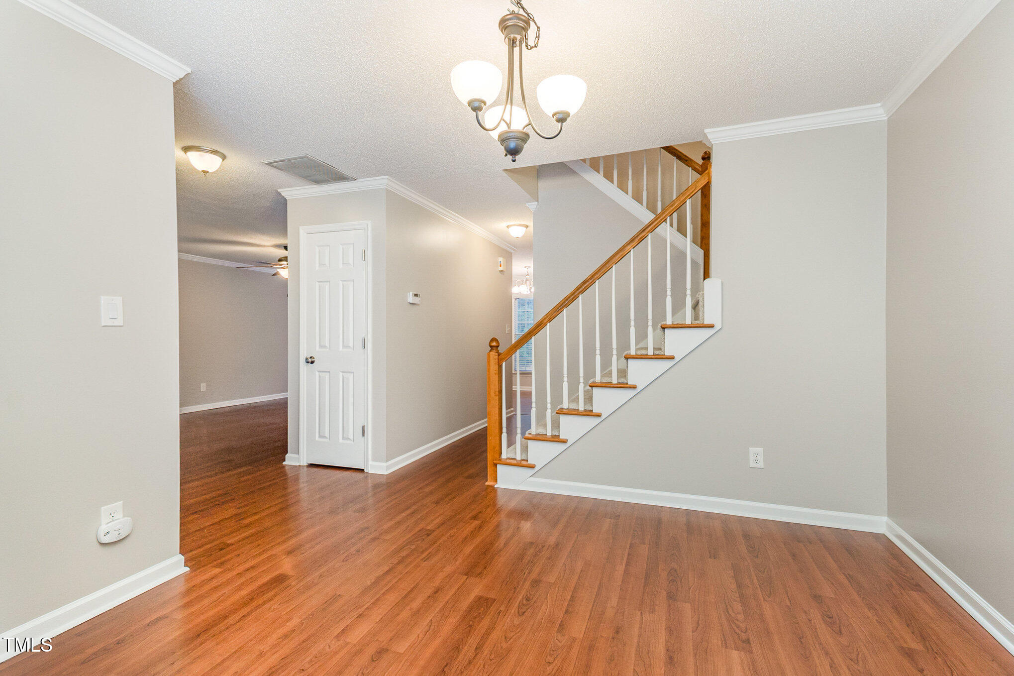 109 Gatepost Lane Cary, NC 27513 - Photo 10 of 37 a view of a hallway with wooden floor and staircase