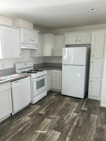 a kitchen with a white cabinets and white appliances