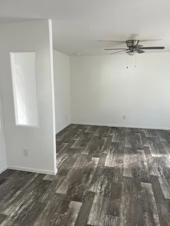 a view of a room with wooden floor