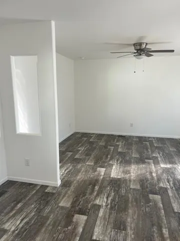 a view of a room with wooden floor