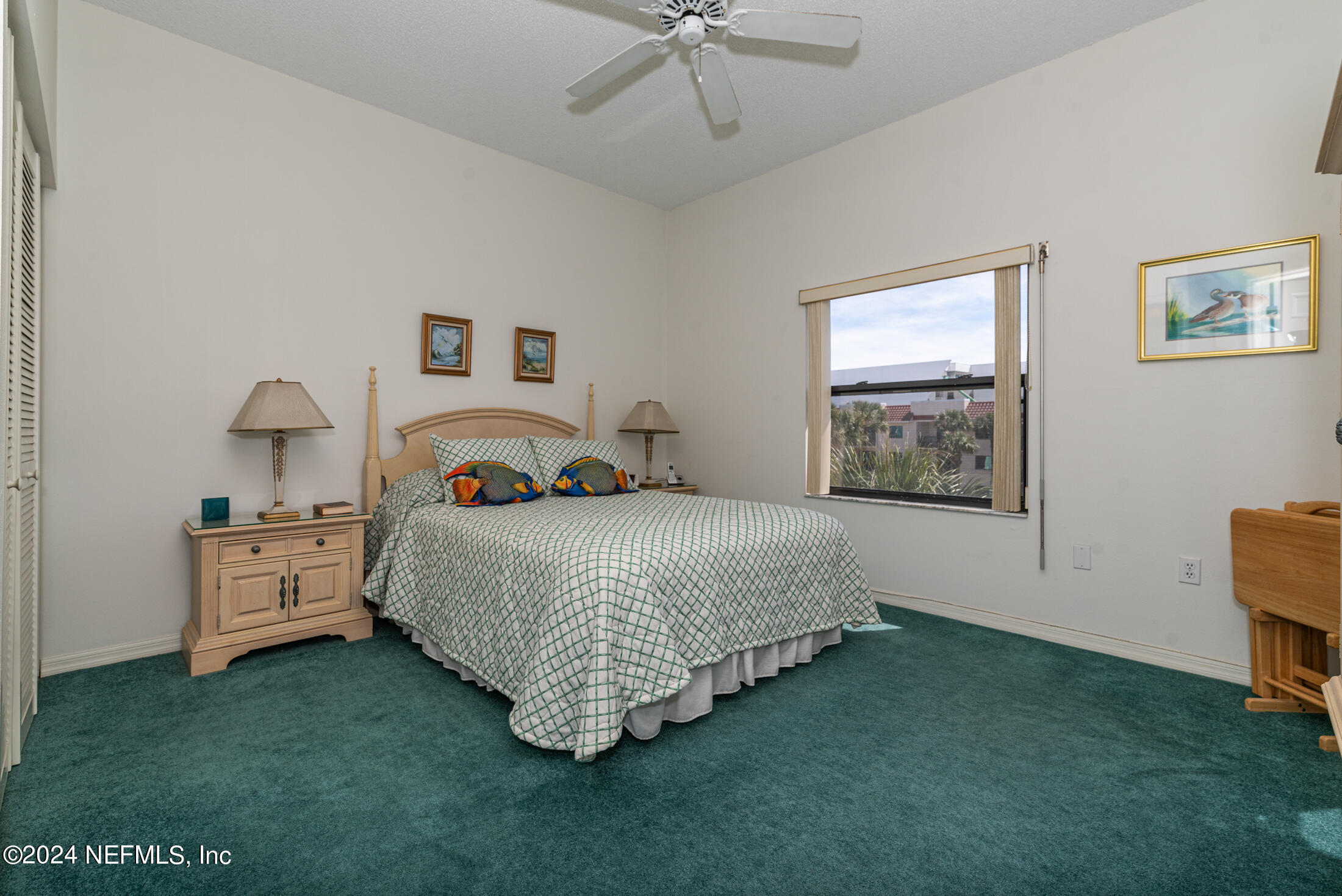 4250 A1A South, Unit Q31 (ELEVATOR) St. Augustine, FL 32080 - Photo 20 of 45 a bedroom with a bed and a chandelier