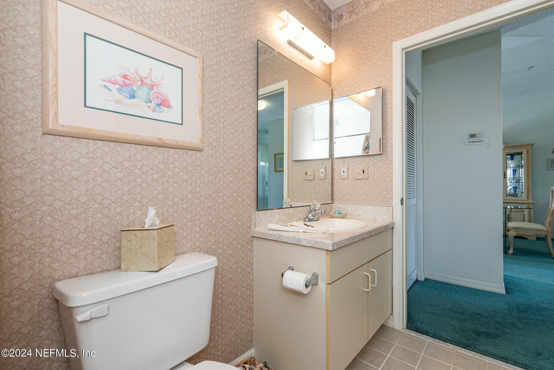 4250 A1A South, Unit Q31 (ELEVATOR) St. Augustine, FL 32080 - Photo 31 of 45 a bathroom with a toilet a sink and mirror