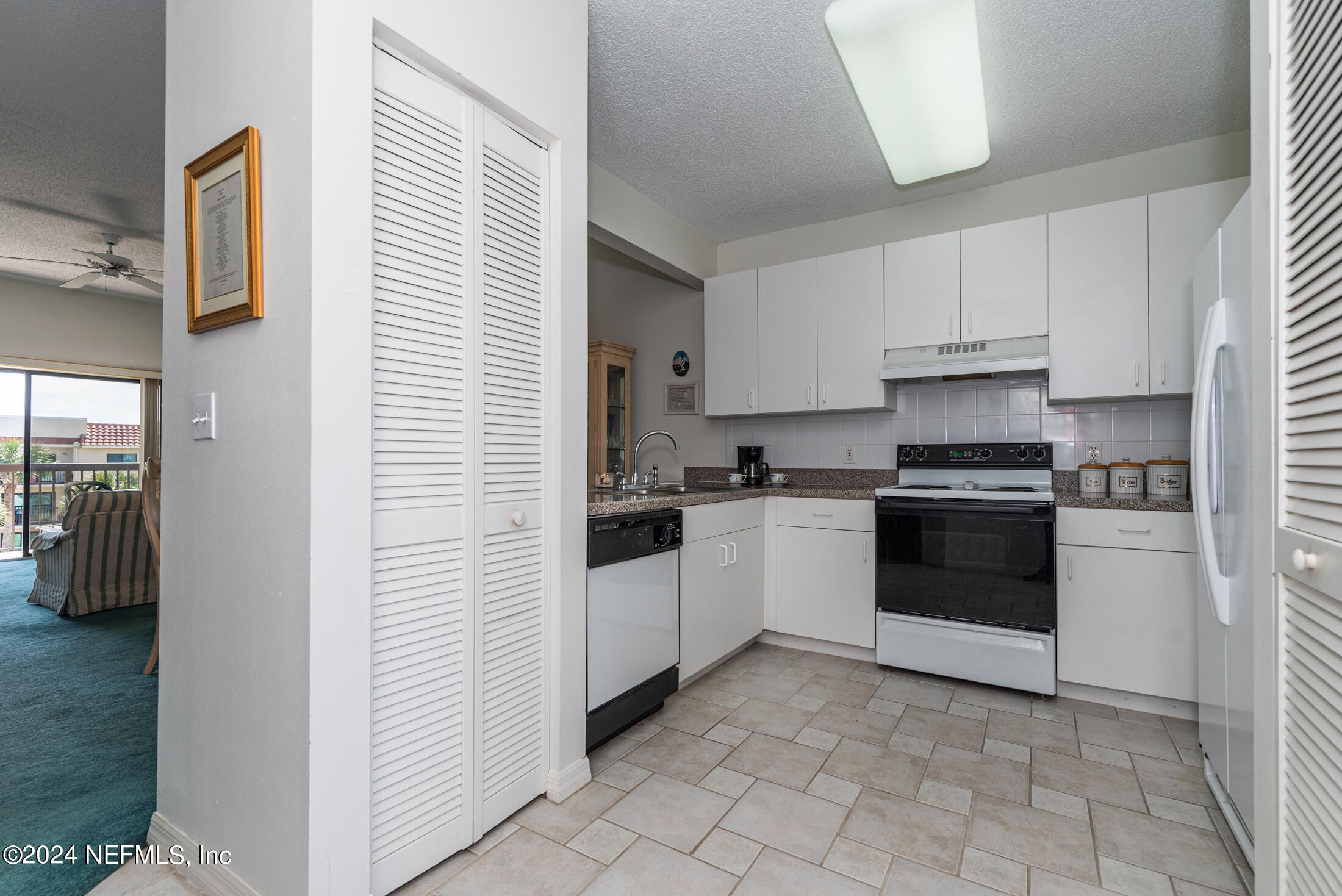 4250 A1A South, Unit Q31 (ELEVATOR) St. Augustine, FL 32080 - Photo 4 of 45 a kitchen with cabinets and white appliances
