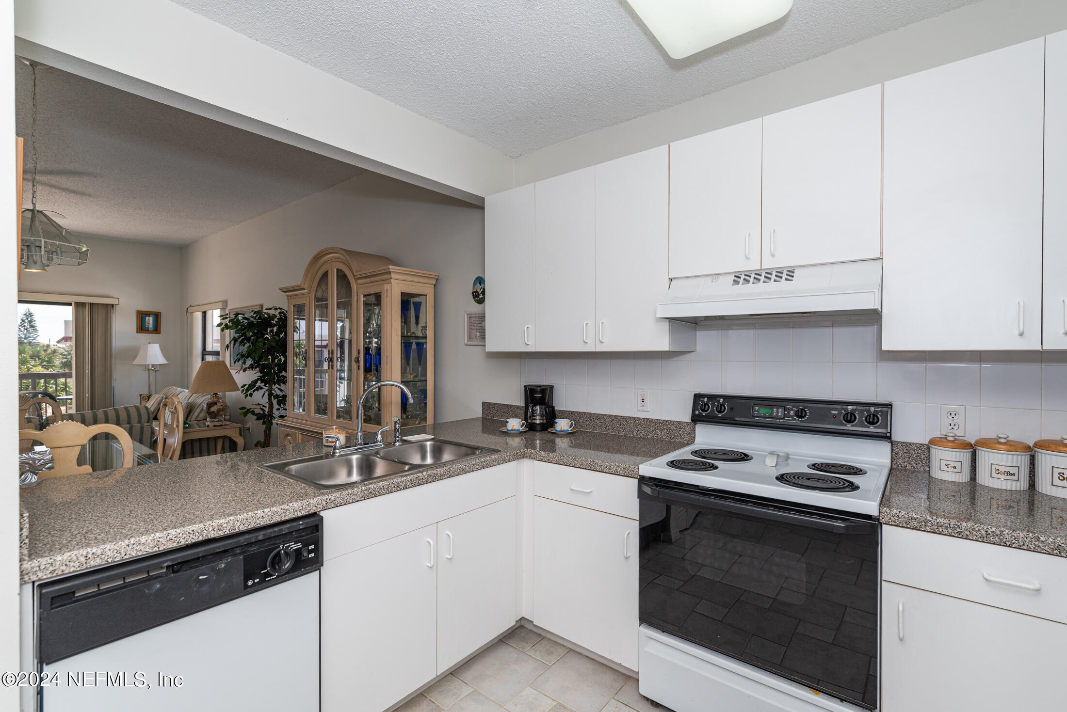 4250 A1A South, Unit Q31 (ELEVATOR) St. Augustine, FL 32080 - Photo 5 of 45 a kitchen with cabinets appliances a sink and a counter top space