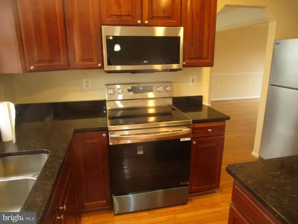 a stove top oven sitting inside of a kitchen