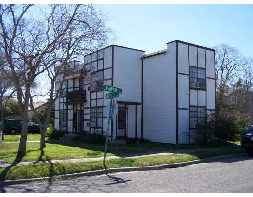 a brick building with a yard and a large window