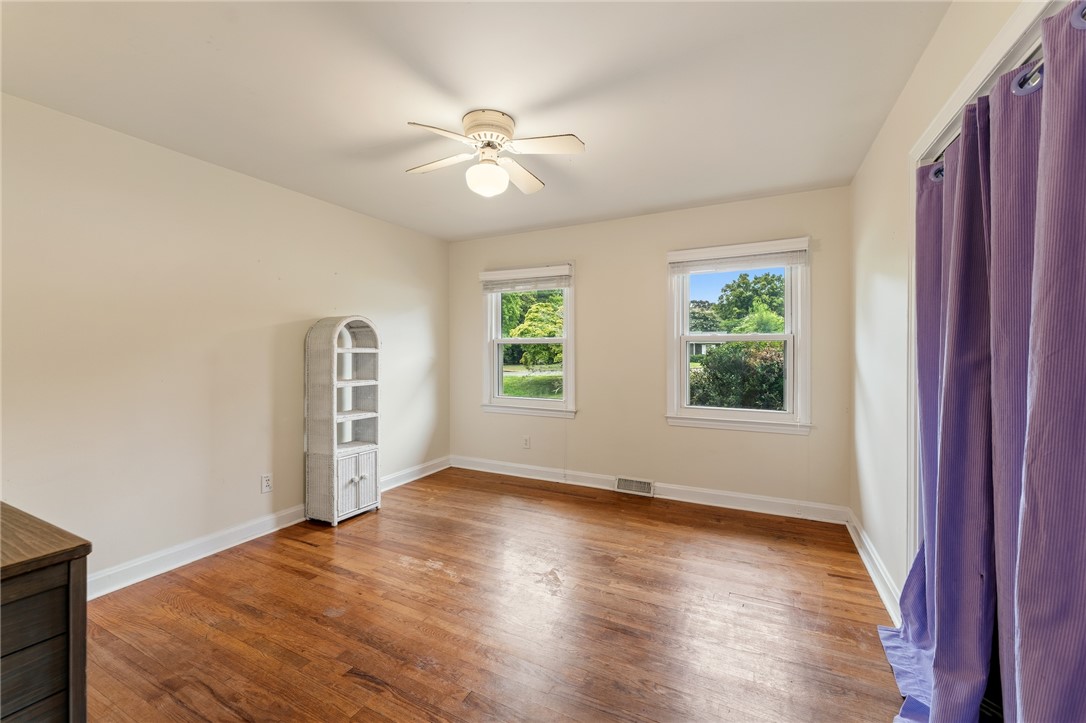 2807 Bellview Road Anderson, SC 29621 - Photo 17 of 31 Rich hardwood flooring and classic double-hung windows define this inviting bedroom space.