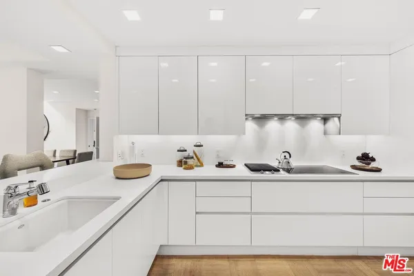 a kitchen with a sink a stove and cabinets
