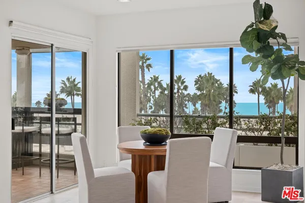a living room with a large window and a floor to ceiling window
