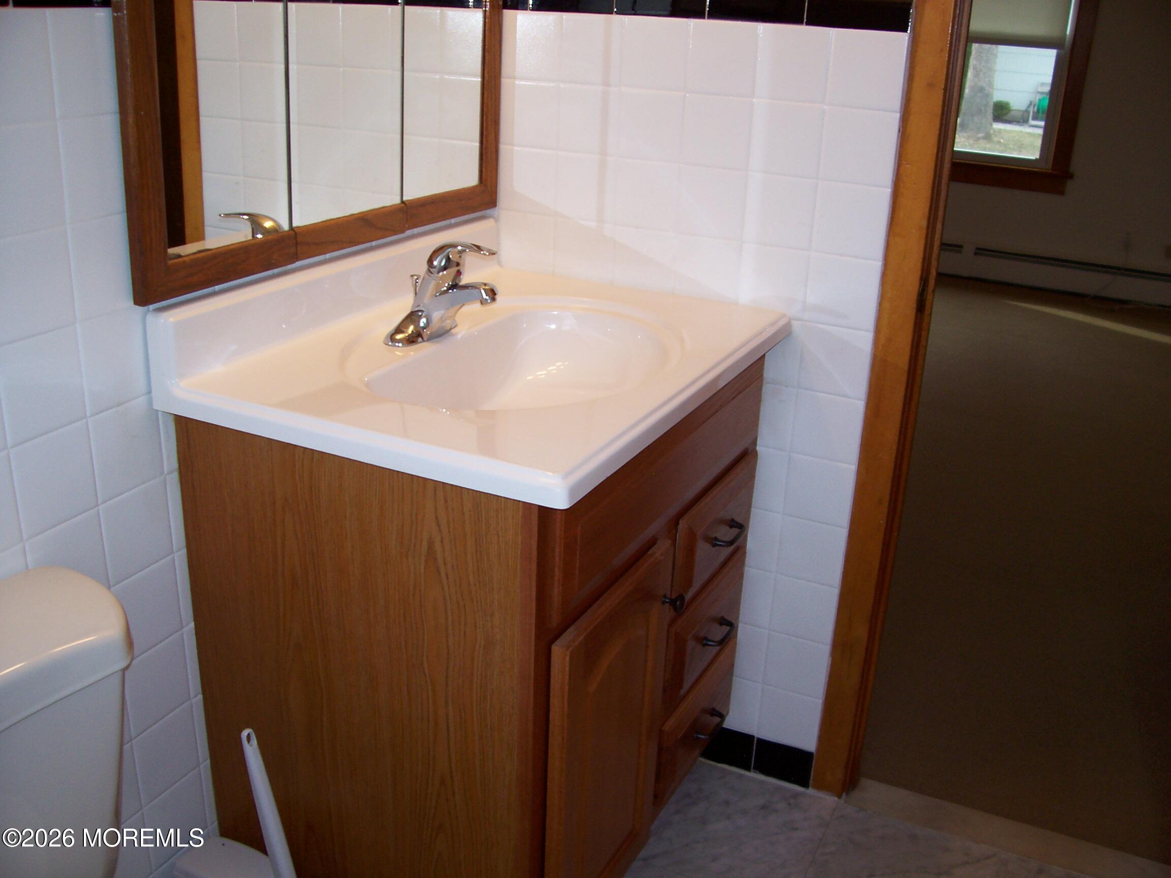 7 Houston Street Red Bank, NJ 07701 - Photo 25 of 38 a bathroom with a sink and a mirror