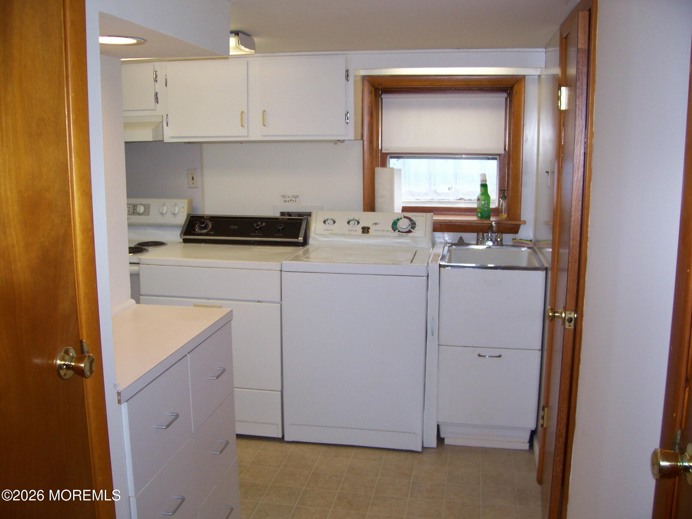 7 Houston Street Red Bank, NJ 07701 - Photo 33 of 38 a kitchen with a sink a stove and cabinets