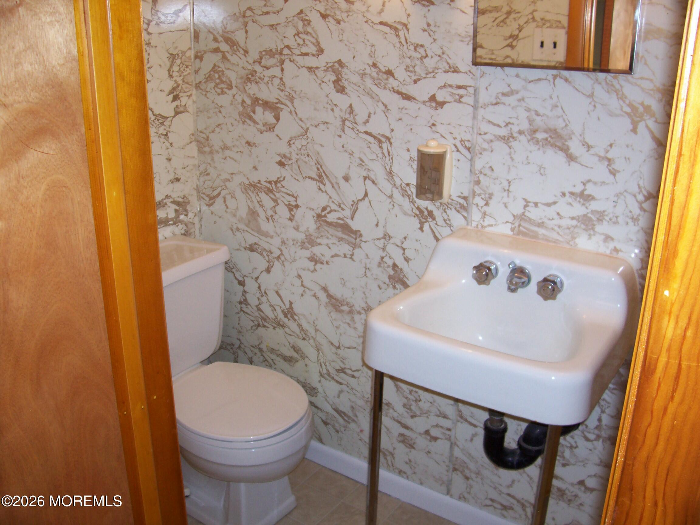 7 Houston Street Red Bank, NJ 07701 - Photo 35 of 38 a bathroom with a sink a toilet and a mirror