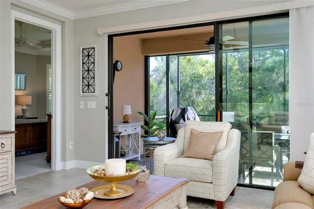 a dining room with furniture a chandelier and window