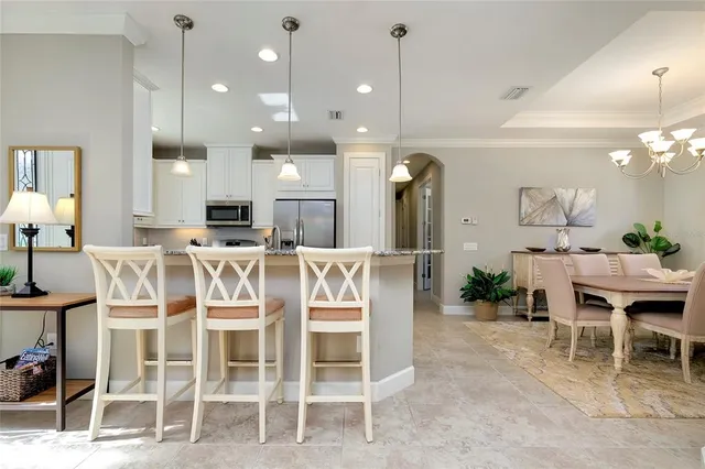 a kitchen with granite countertop white cabinets and appliances