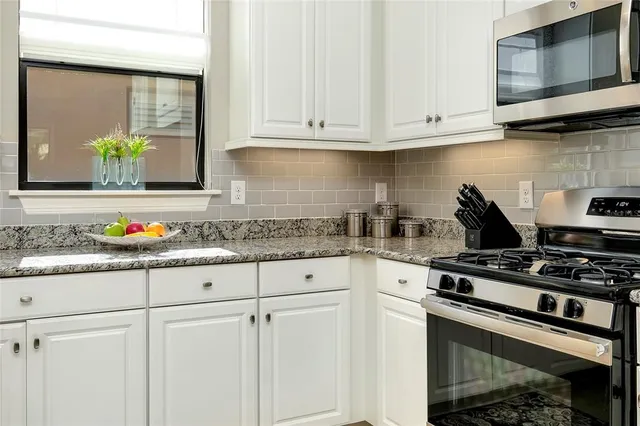 a living room with furniture a desk and a workspace