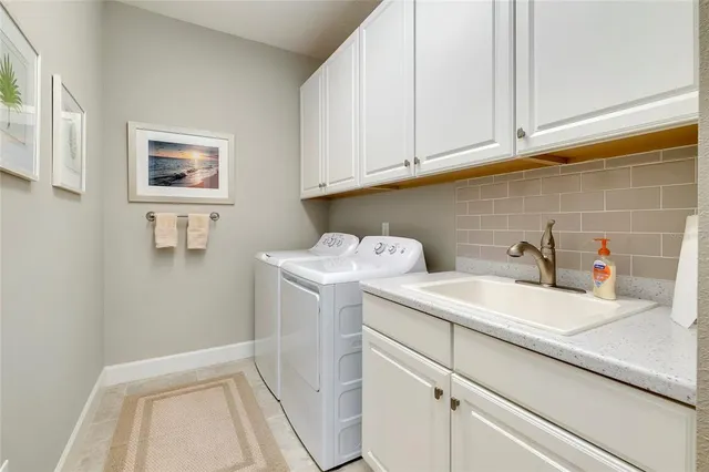 a view of a big house with a big yard and palm trees