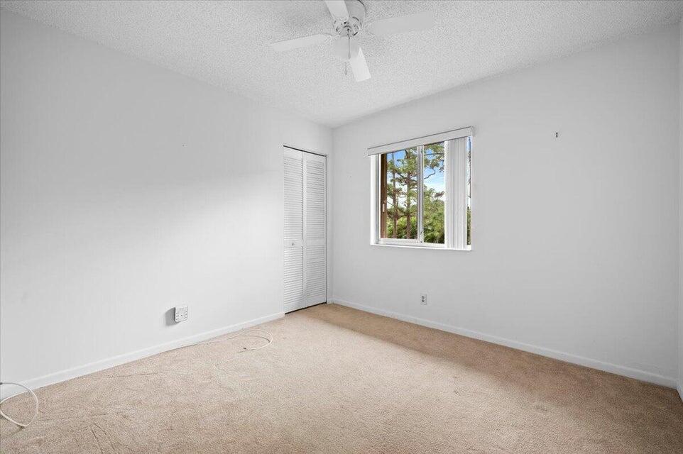 436 Pine Glen Lane, Unit B2 Greenacres, FL 33463 - Photo 12 of 19 an empty room with a window