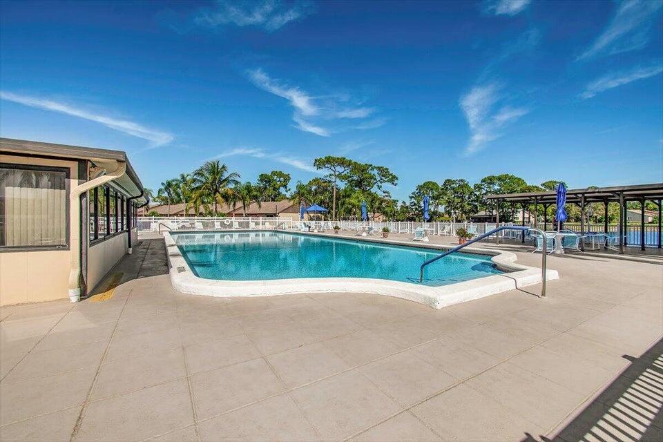 436 Pine Glen Lane, Unit B2 Greenacres, FL 33463 - Photo 14 of 19 a view of swimming pool with a yard and plants