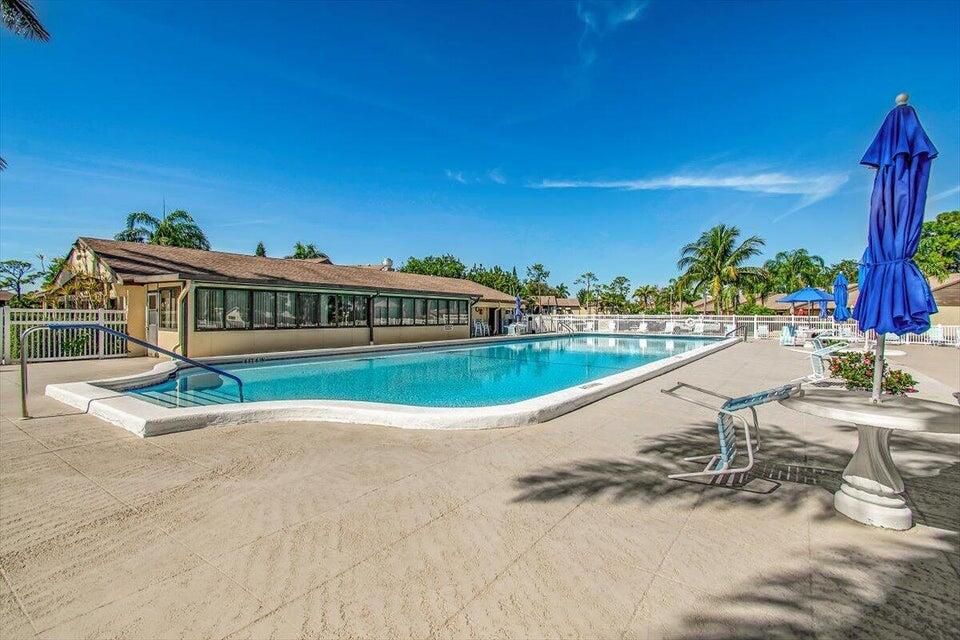 436 Pine Glen Lane, Unit B2 Greenacres, FL 33463 - Photo 16 of 19 a view of a house with a swimming pool