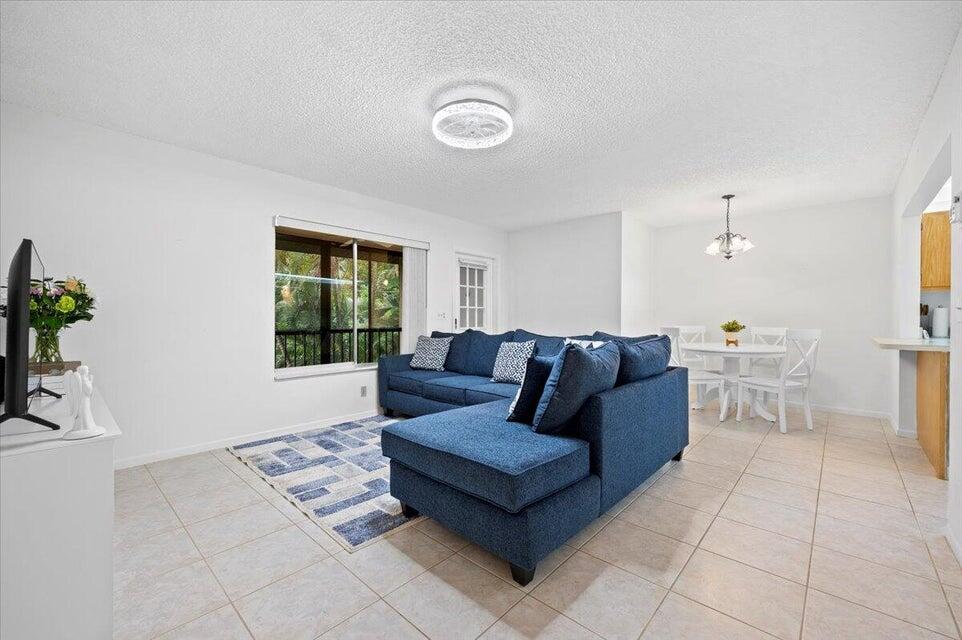 436 Pine Glen Lane, Unit B2 Greenacres, FL 33463 - Photo 2 of 19 a living room with furniture and a window