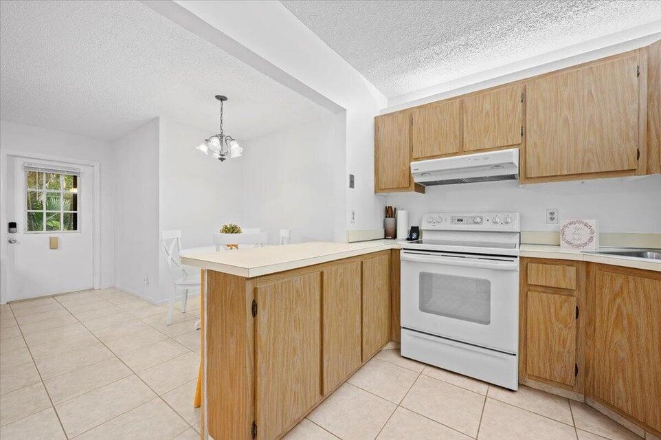436 Pine Glen Lane, Unit B2 Greenacres, FL 33463 - Photo 5 of 19 a kitchen with a sink cabinets and window