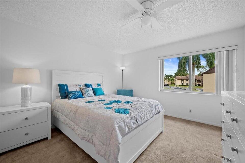 436 Pine Glen Lane, Unit B2 Greenacres, FL 33463 - Photo 10 of 19 a bedroom with a bed and a window