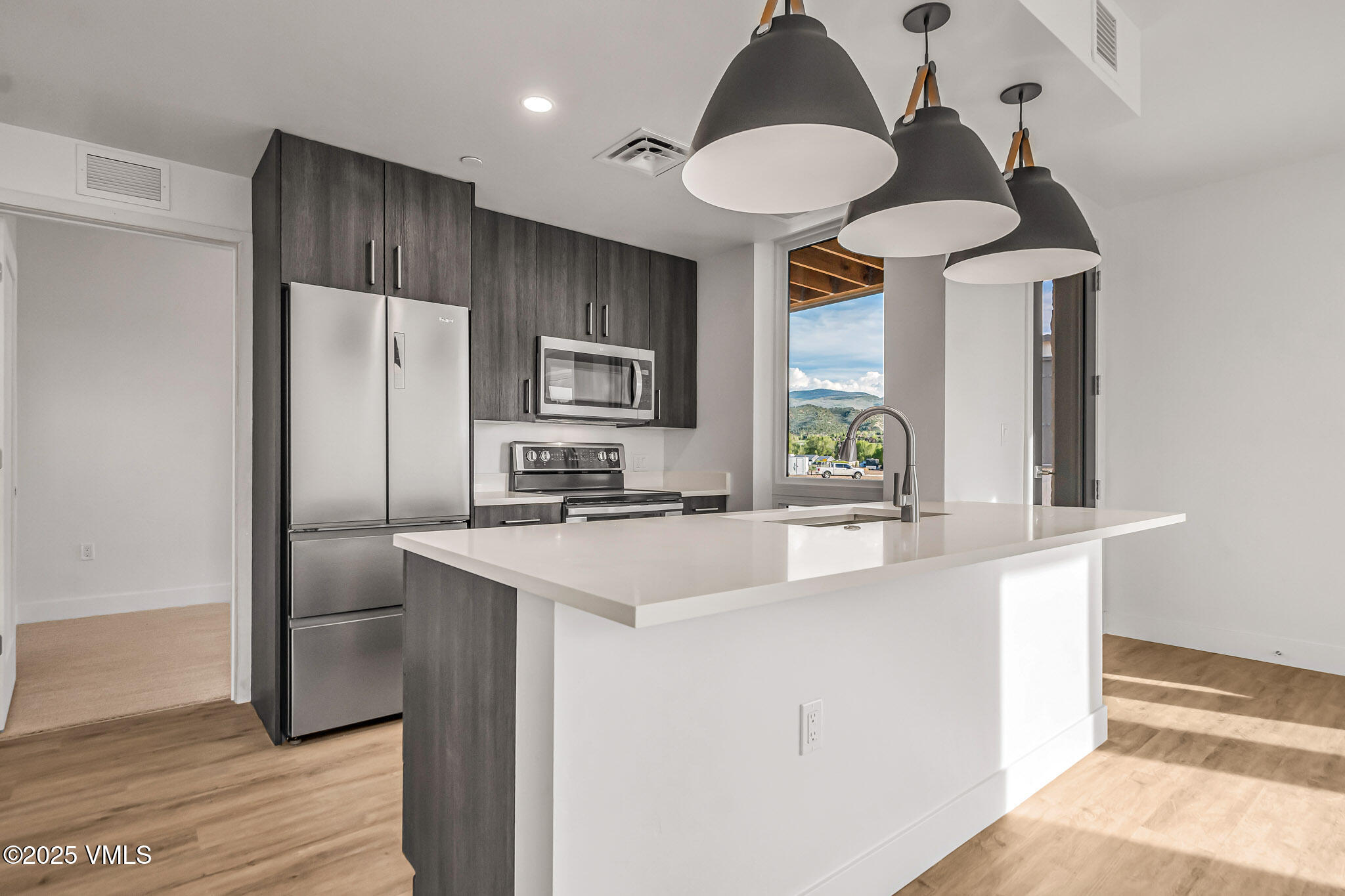 91 Mount Hope Circle, Unit C101 Eagle, CO 81631 - Photo 2 of 14 a kitchen with kitchen island a counter space a sink appliances and cabinets