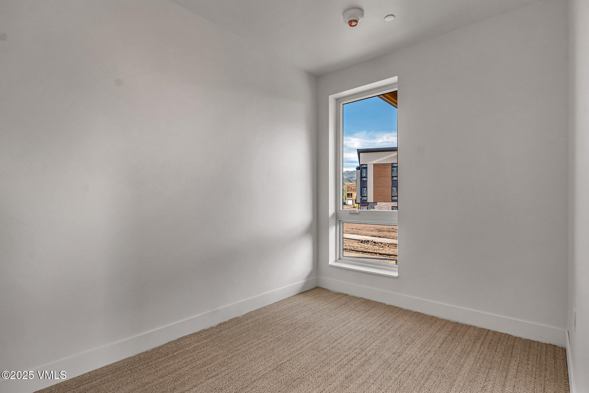 91 Mount Hope Circle, Unit C101 Eagle, CO 81631 - Photo 8 of 14 a view of an empty room with wooden floor and a window
