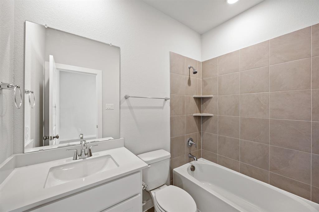 734 Carson Drive Forney, TX 75126 - Photo 11 of 31 a bathroom with a bathtub shower sink vanity and toilet
